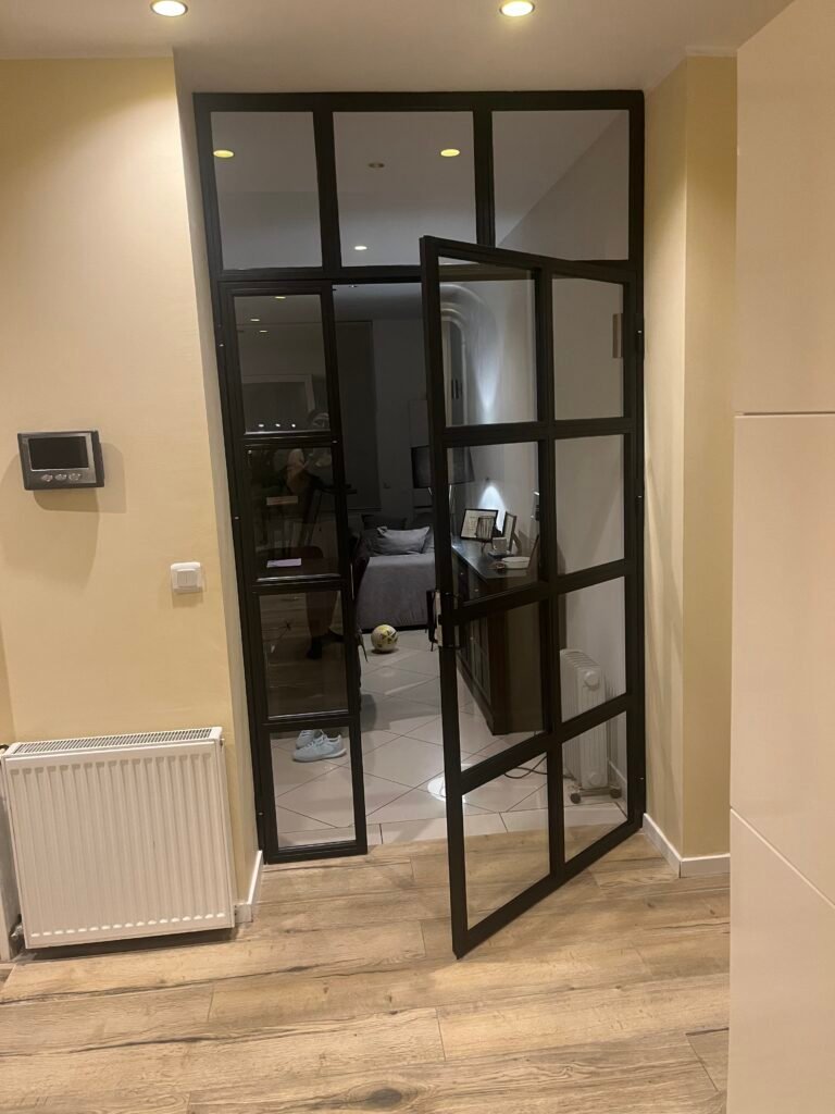 Une porte en verre ouverte avec un cadre en verre